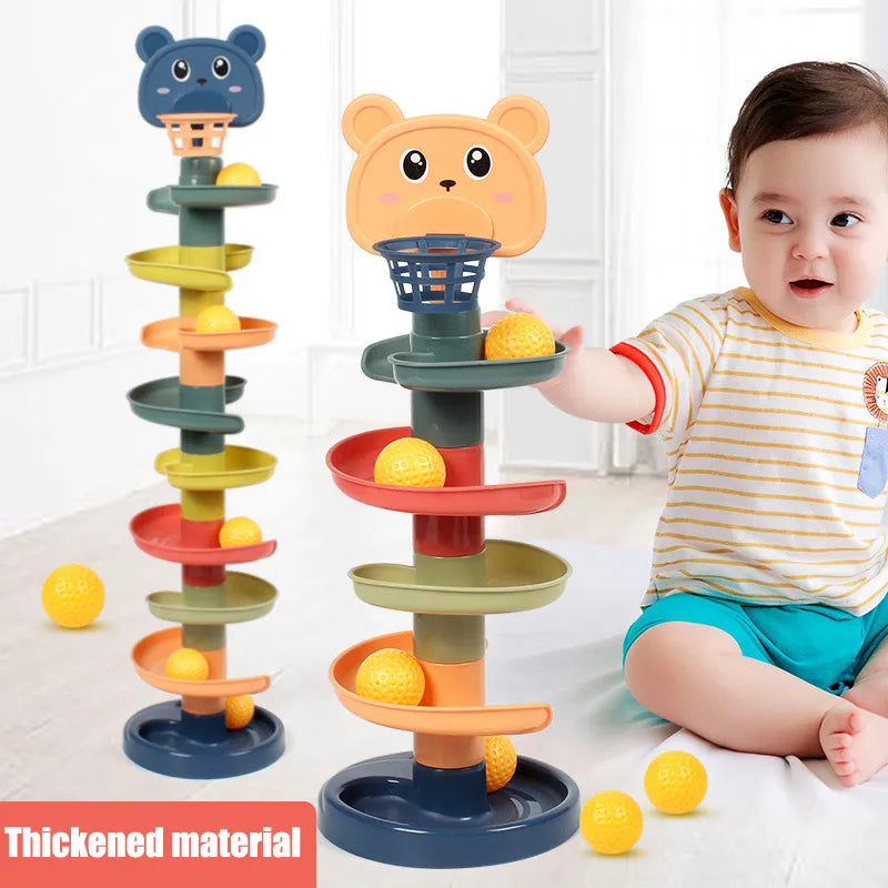 a baby is playing with tower stacking ball slide
