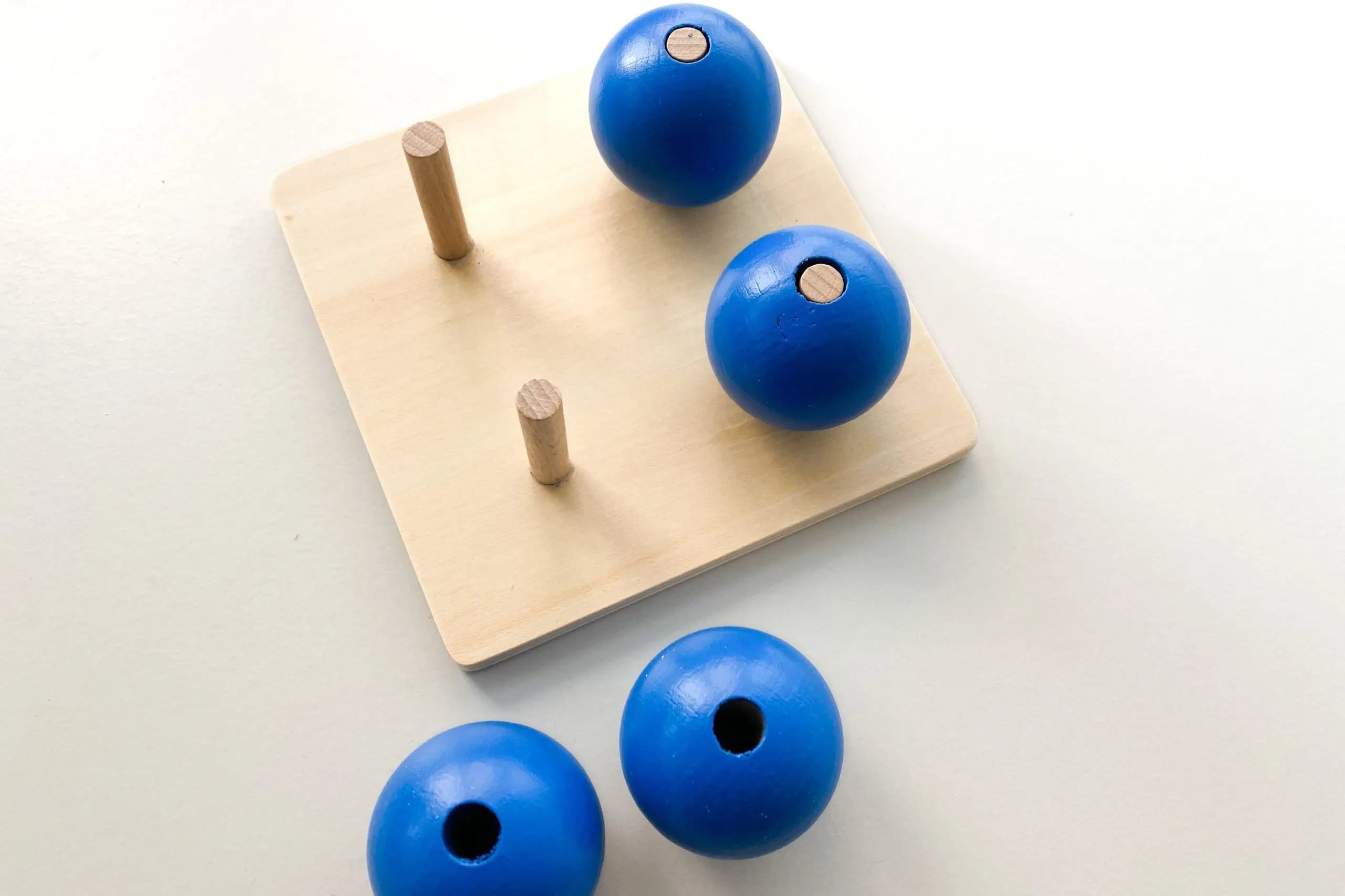 Four Blue Balls On
Small Pegs